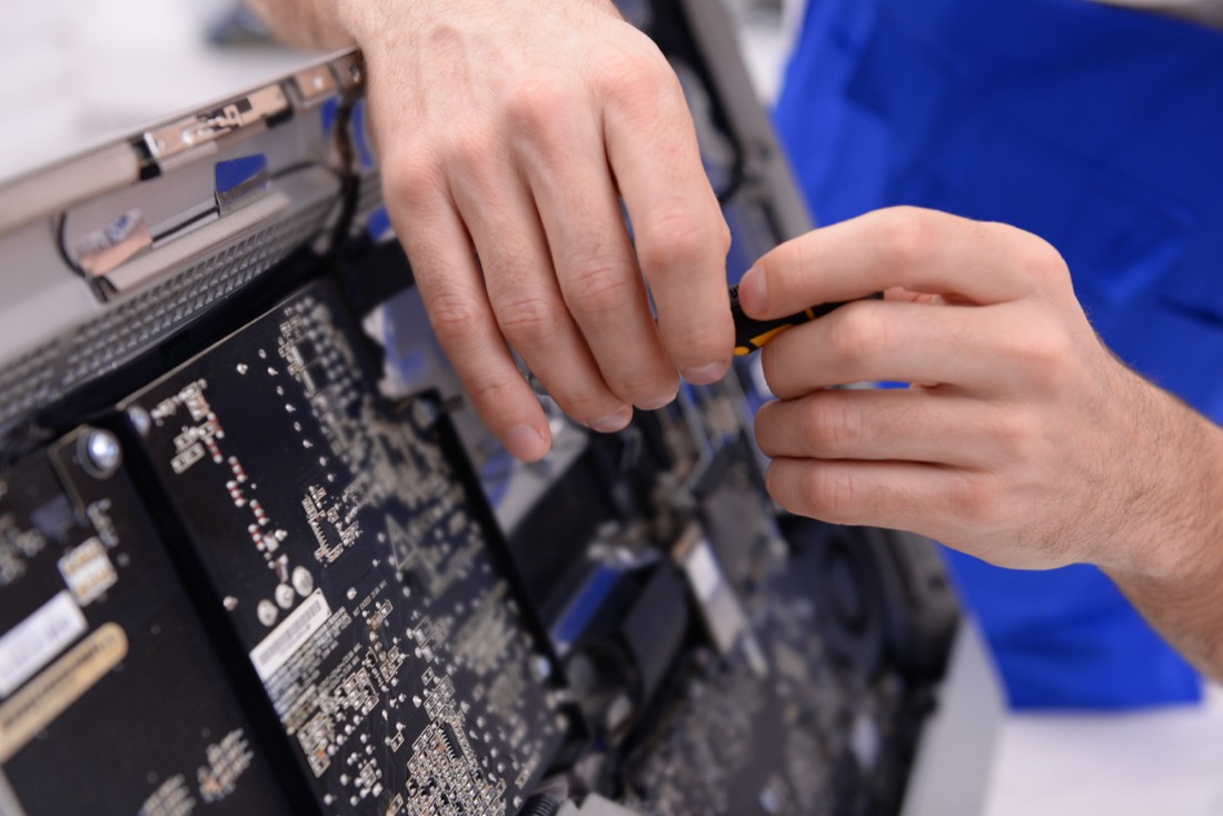 An MGNS technician repairing the mainboard of an electronic device